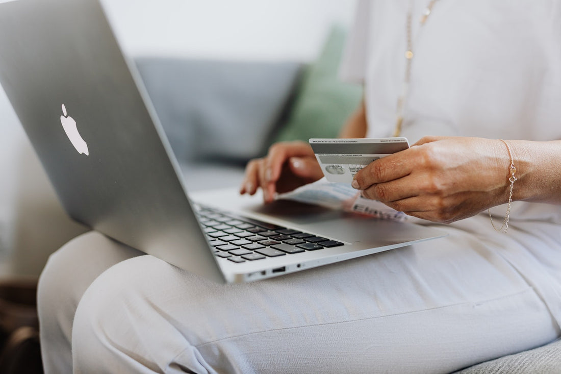 Photo by Karolina Grabowska: https://www.pexels.com/photo/person-using-a-macbook-and-holding-a-credit-card-4968391/ - laptop sitting on someones lap while they hold a credit card