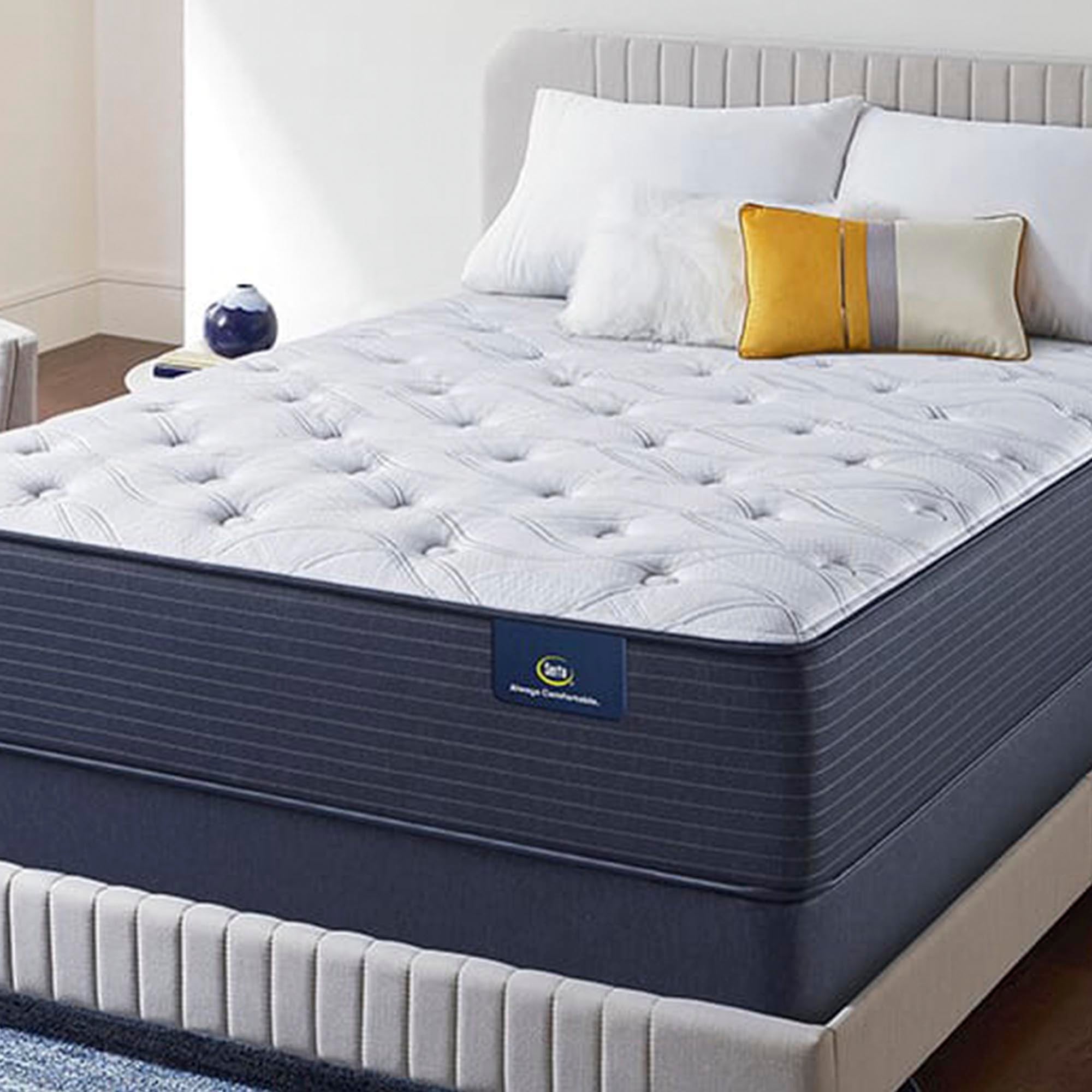 The Serta Classic Elite Plush 14" in a bedroom on a beige bed with pillows