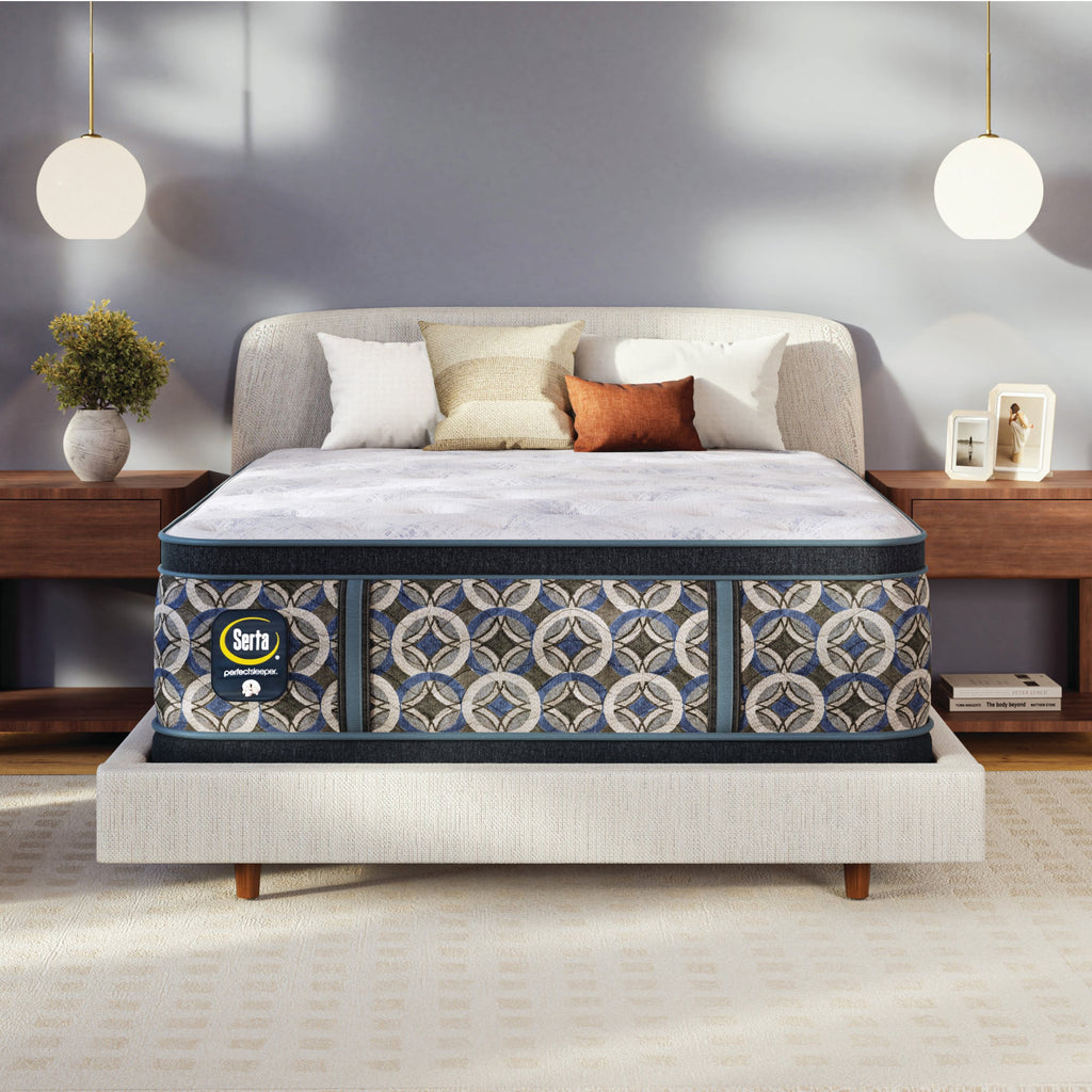 Serta perfect sleeper plush mattress on a bed in a bedroom setting with decor elements.