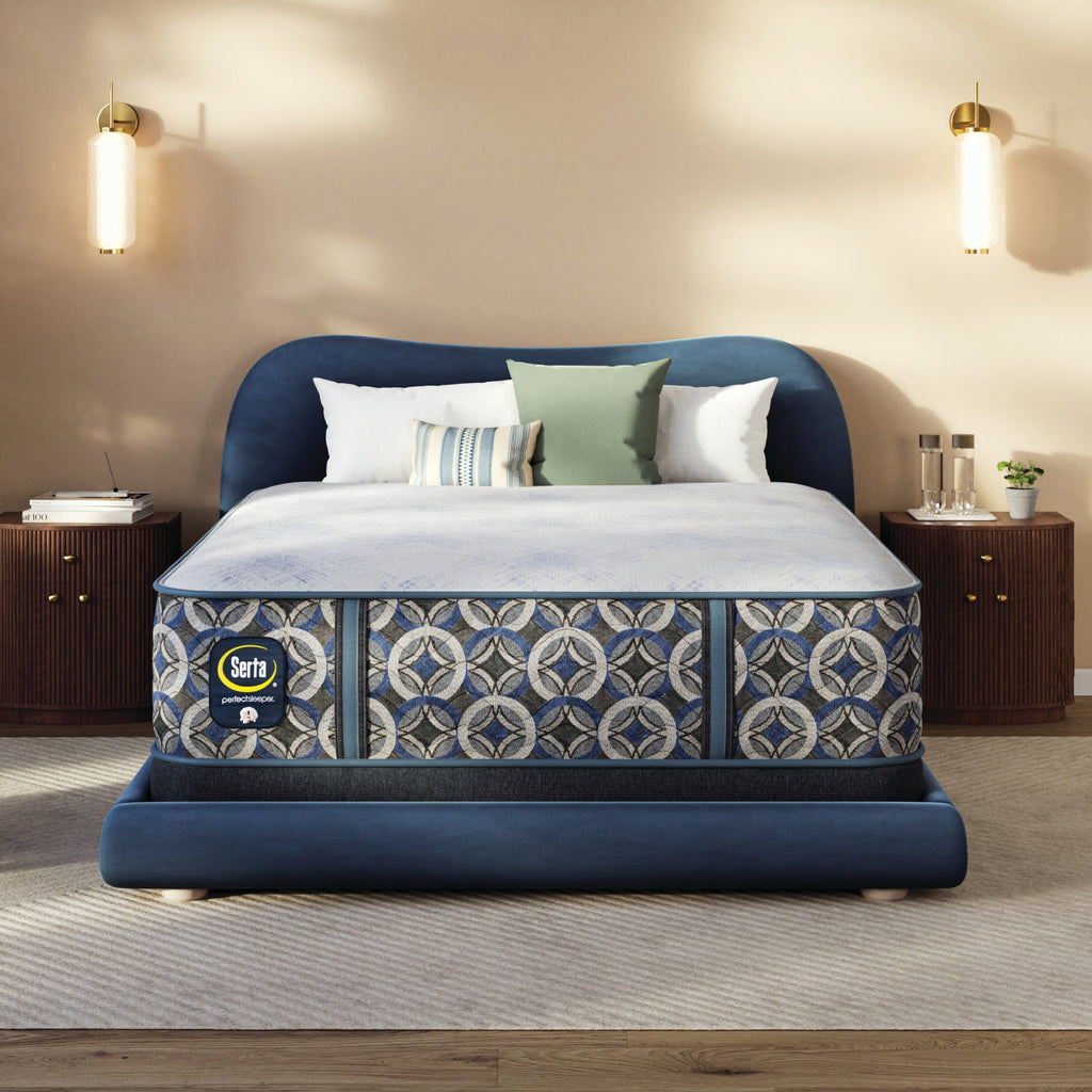 Blue upholstered bed with a Serta perfect sleeper hybrid medium  mattress in a bedroom setting