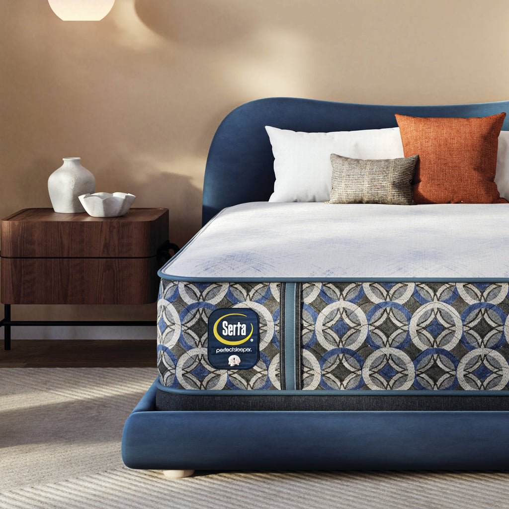 Serta pefect sleeper hybrid plush  mattress with decorative headboard and pillows in a bedroom setting