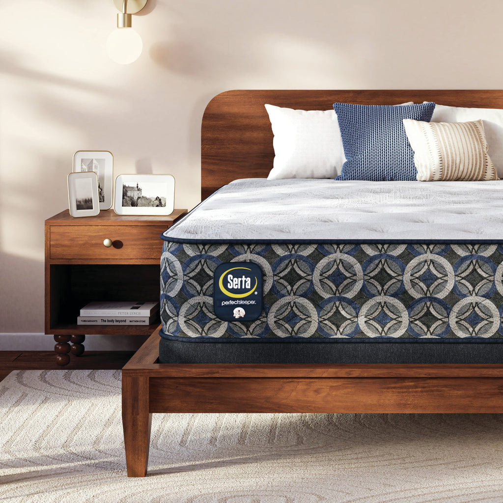 Serta Perfect Sleeper medium mattress on a wooden bed in a bedroom setting with nightstand and decor.