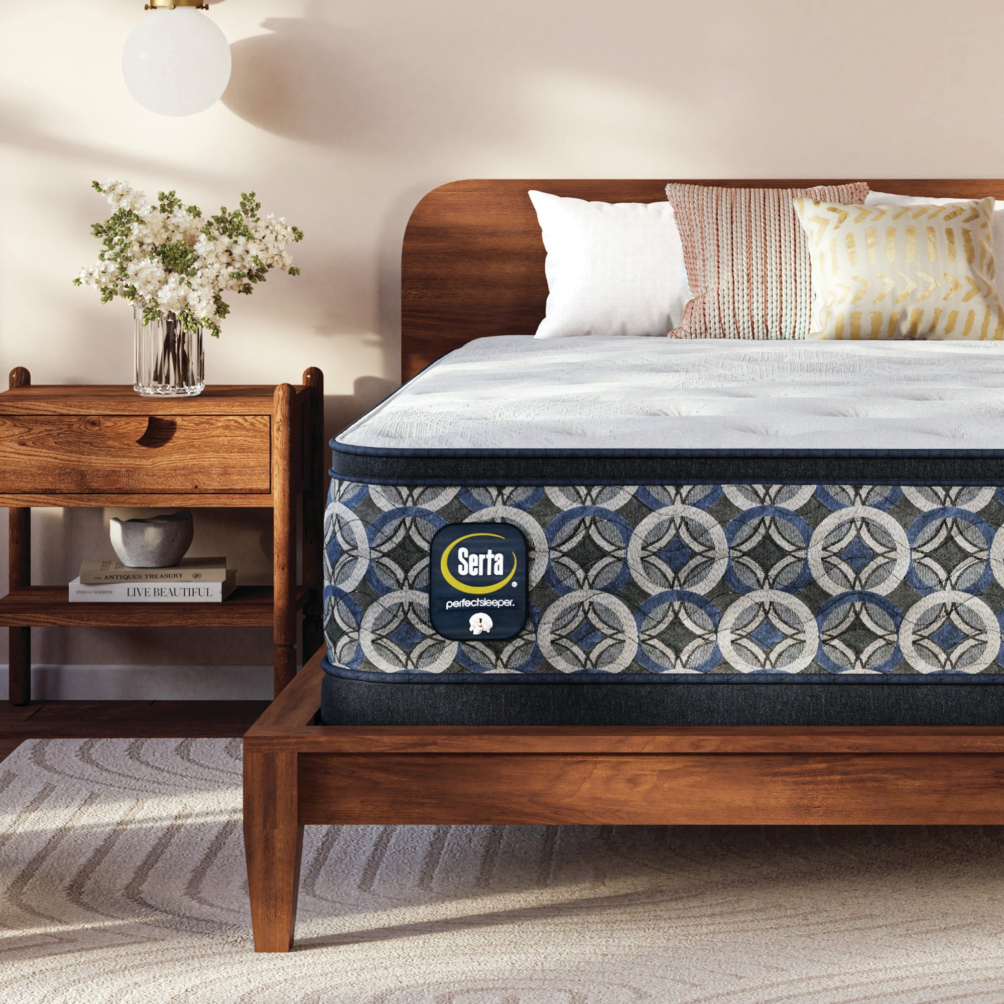 Serta perfect sleeper medium mattress on a wooden bed frame in a bedroom setting