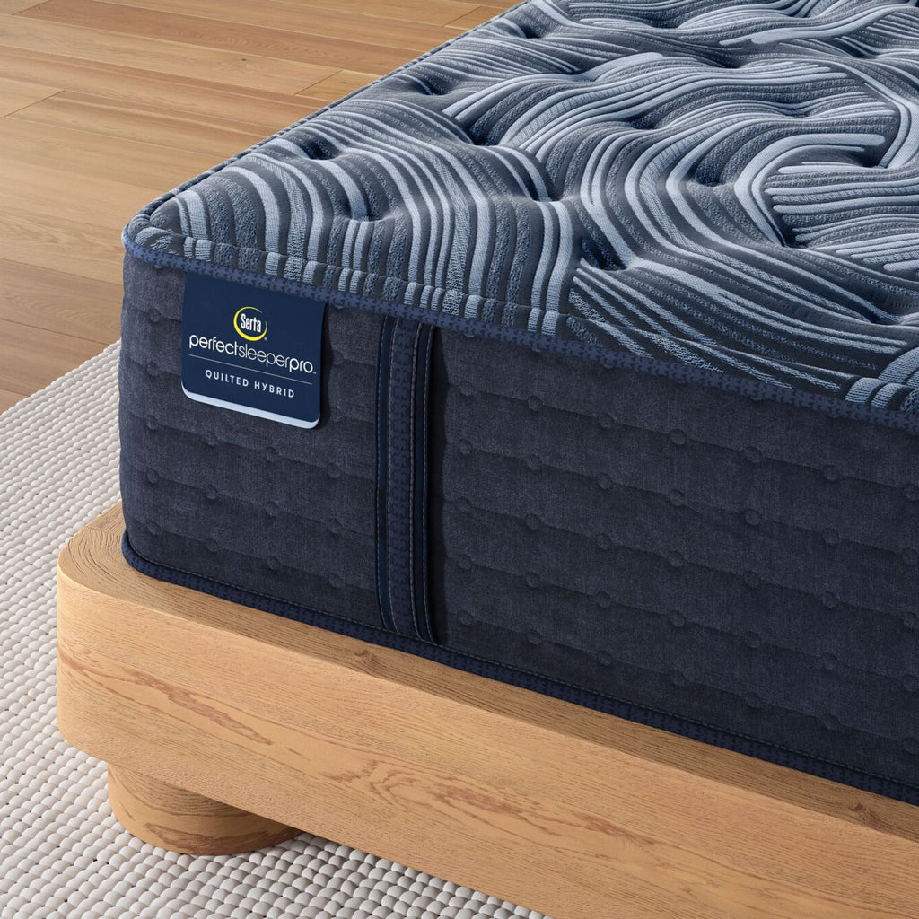 Corner of Perfect Sleeper Pro New Paris Medium mattress sitting in a brown bedframe || Level: Level 3 || Feel: Medium
