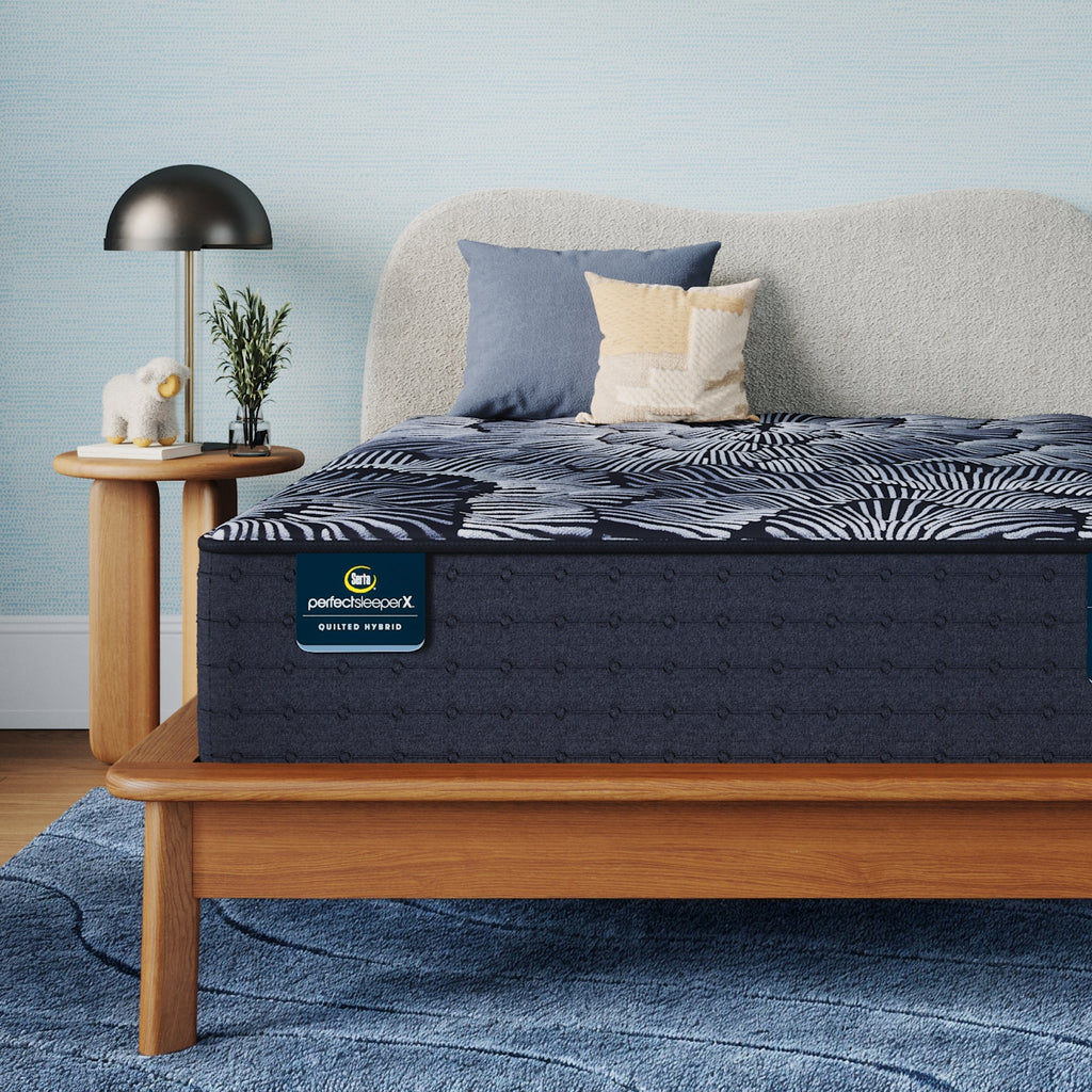 Perfect Sleeper X Quilted Hybrid Excelled Plush Mattress sitting in a brown bedframe || feel: Enhanced Plush || level: Level 1