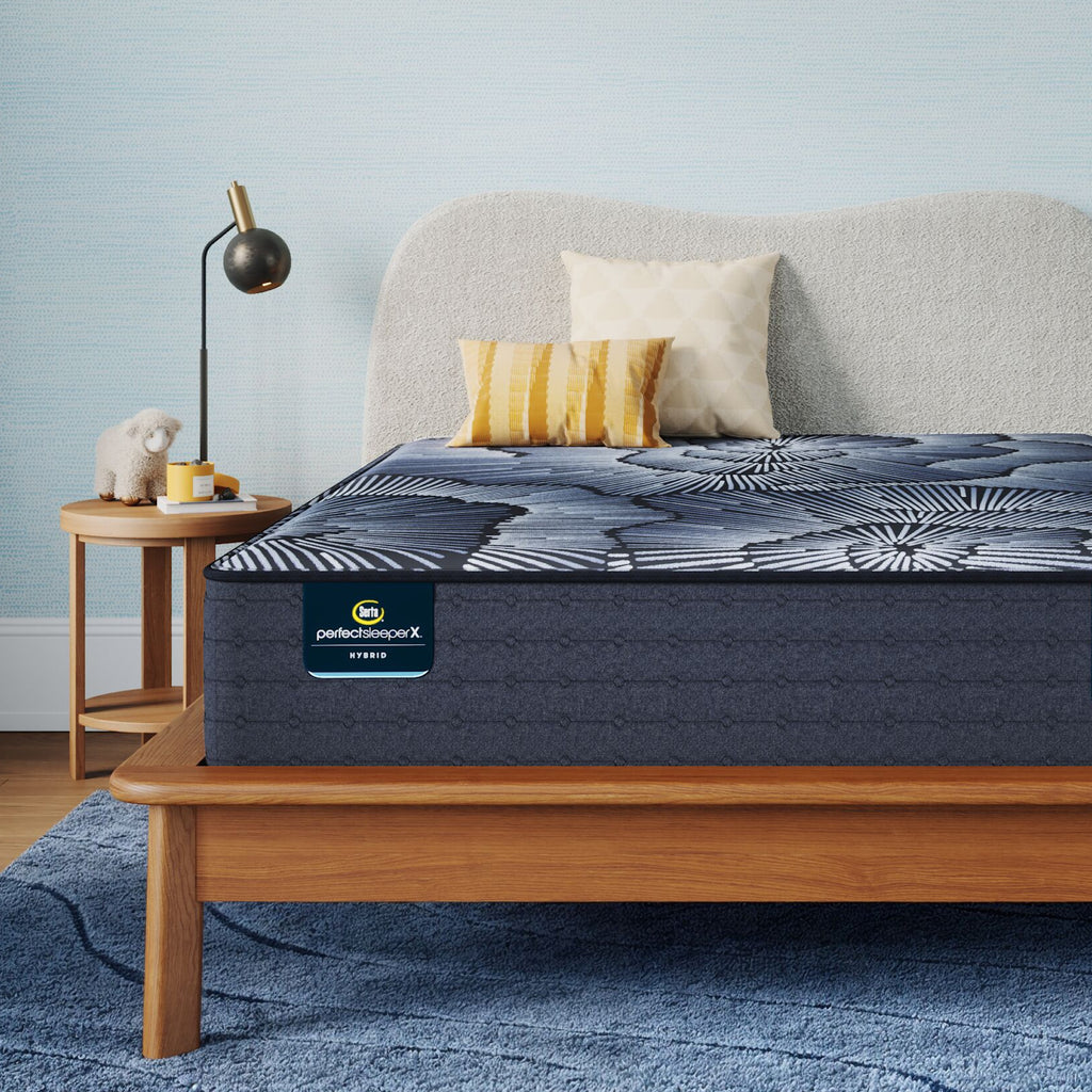 Perfect Sleeper X Hybrid Aspen Firm Mattress sitting in a brown bedframe || feel: firm || level: Level 1