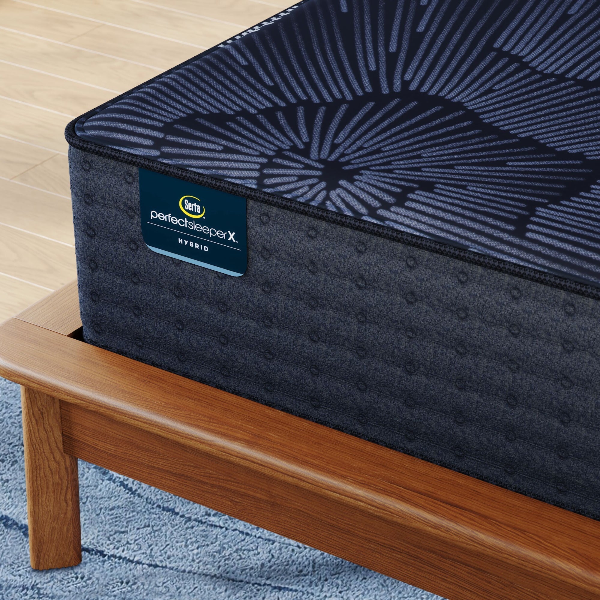 Corner of Perfect Sleeper X Hybrid Prescot Medium Firm Mattress sitting in a brown bedframe || feel: Medium Firm || level: Level 2
