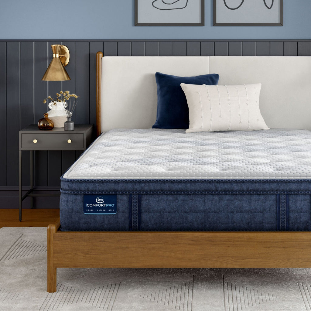 iComfortPro Dartmouth Pillow Top Mattress sitting in a brown bedframe || feel: plush pillow top || level: Level 2