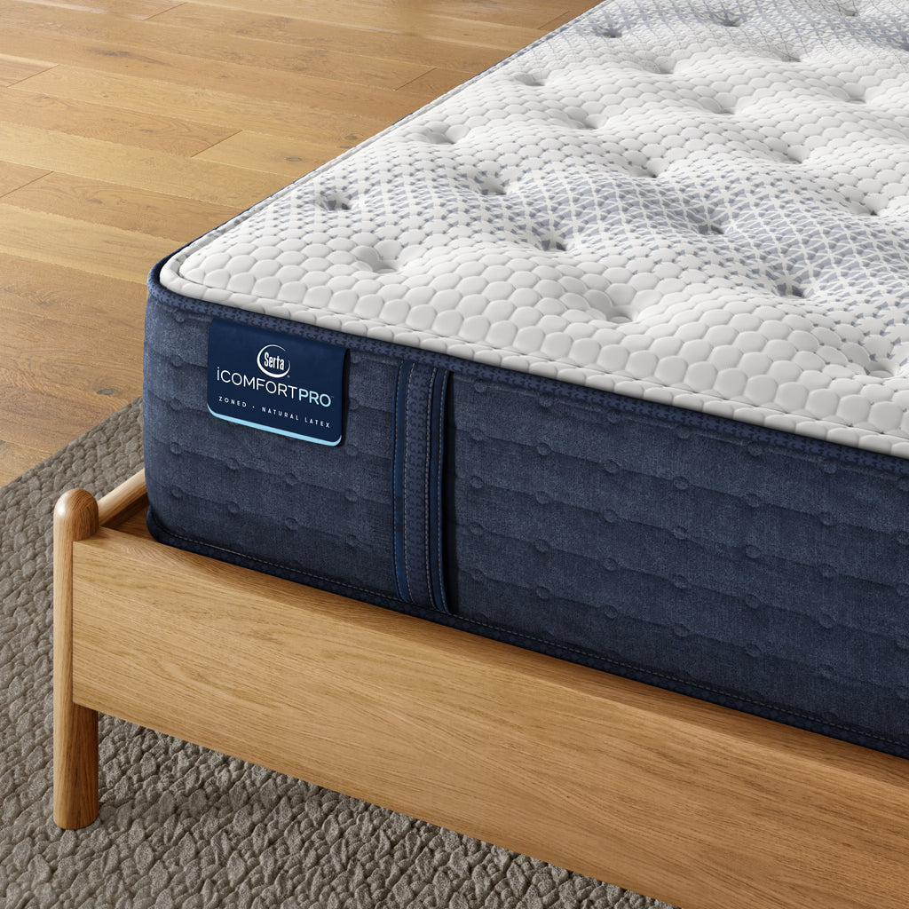 Corner of iComfortPro Ambrose Plush Mattress sitting in a brown bedframe || feel: plush || level: Level 2
