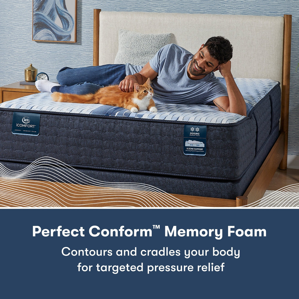 Man laying across a Serta iComfort mattress petting a cat || feel: medium || level: Standard - 12"