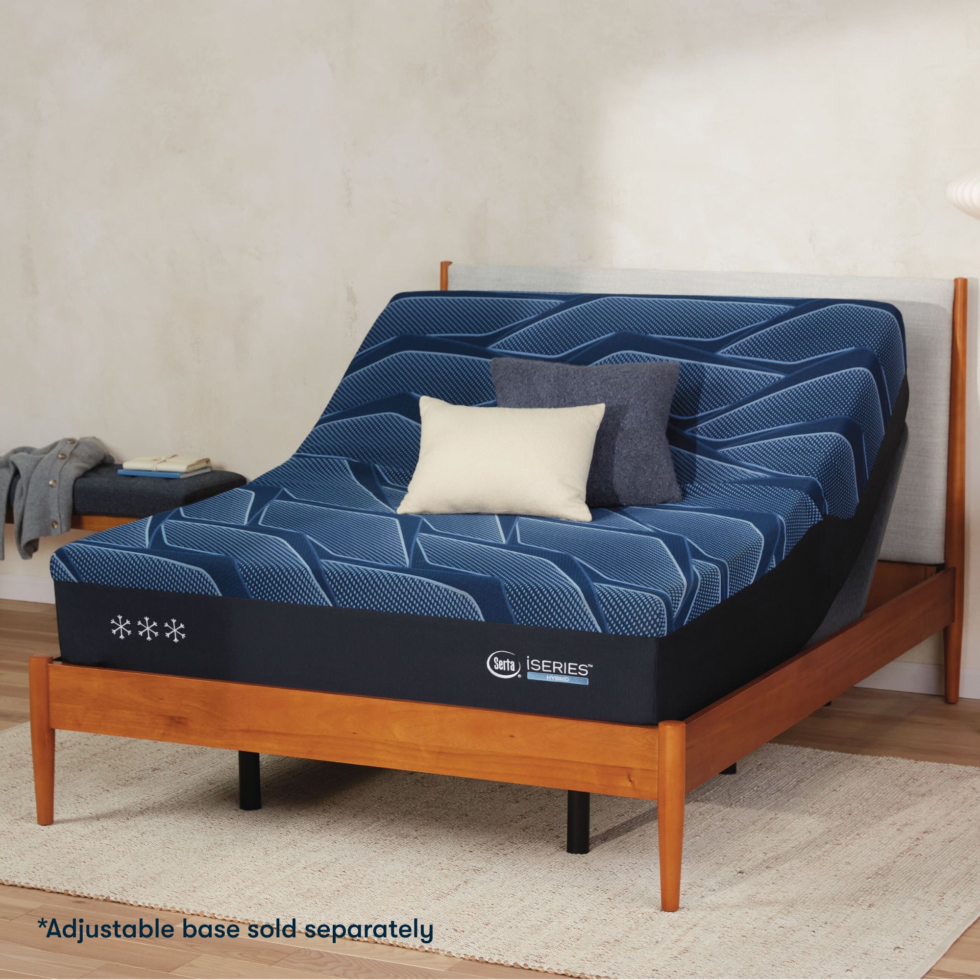 Serta iSeries medium blue mattress sitting in a adjustable frame, in a brown bed with a blue and white pillow on top||feel: medium||level: Ultimate