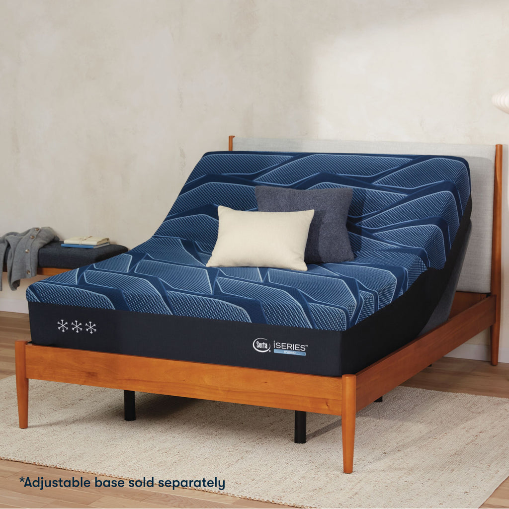 Serta iSeries plush blue mattress sitting in a adjustable frame, in a brown bed with a blue and white pillow on top||feel: plush||level: Ultimate