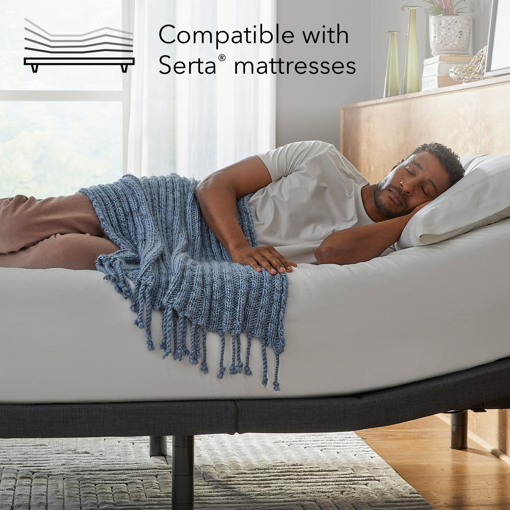 Man laying asleep on a white mattress sitting on a Baselogic Platinum Adjustable Base