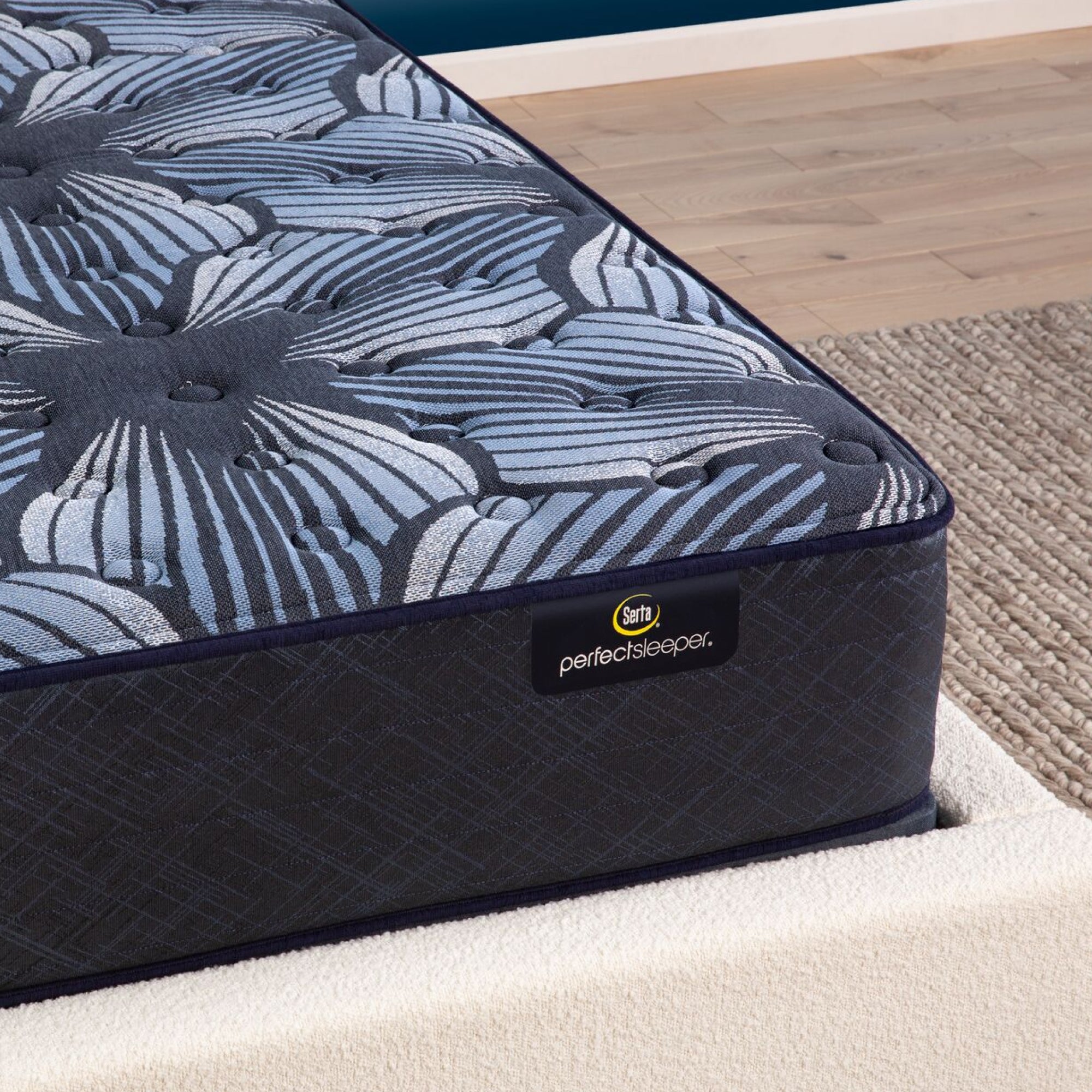 Corner view of the  Serta Perfect Sleeper Sleep Excellence mattress in a bedroom | feel: Extra Firm