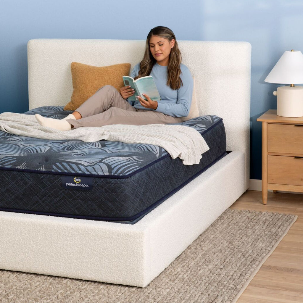 A woman reading in bed on the Serta Perfect Sleeper Sleep Excellence mattress | feel: plush