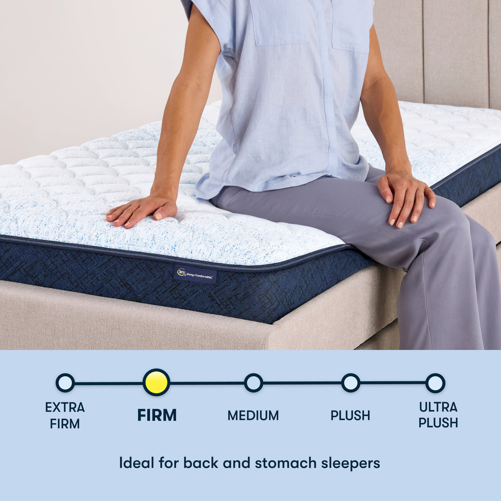 Woman sitting on the right of a 6 inch foam mattress sitting in a beige bedframe || feel: Foam (6" Profile)