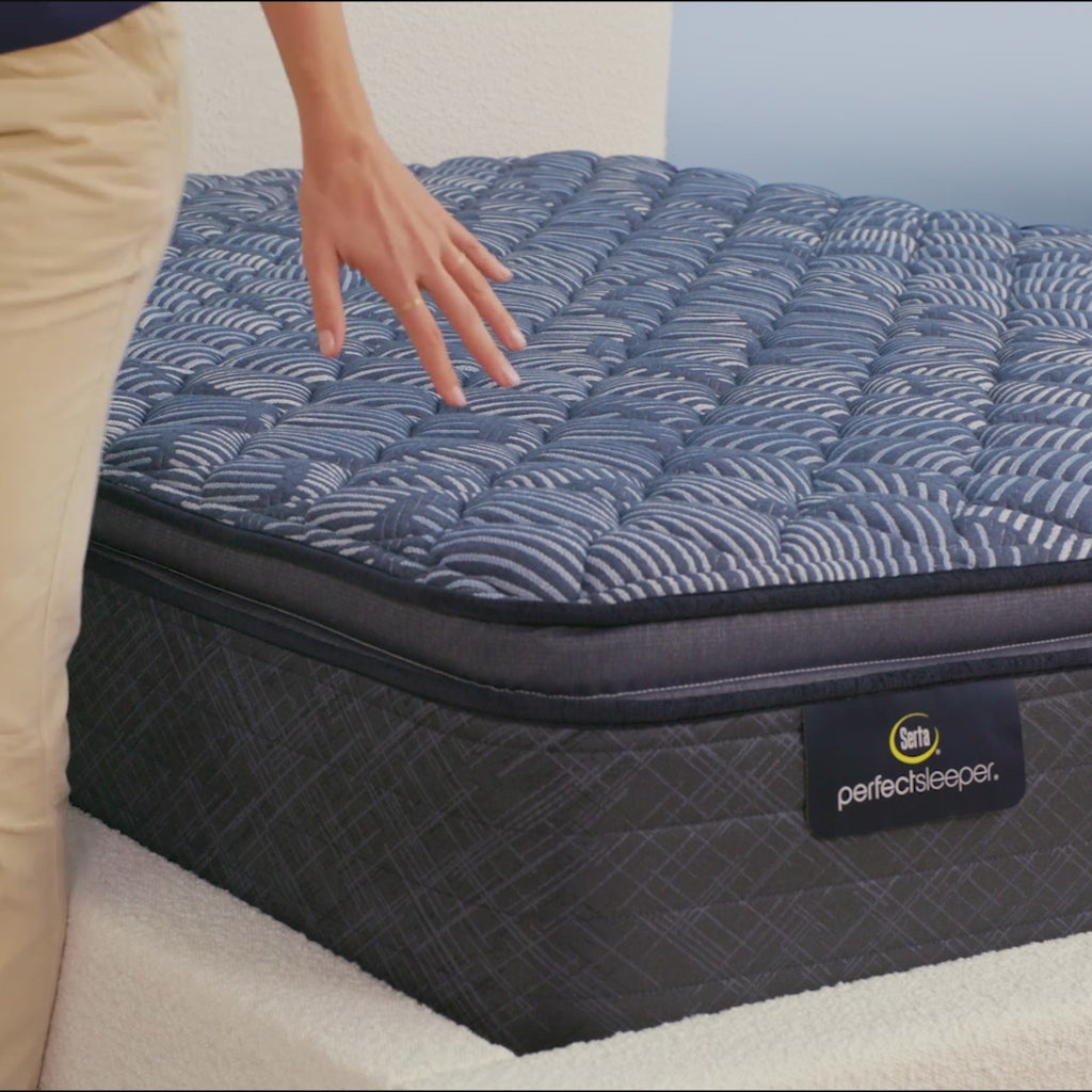 Person sitting on bed to show firmness level of Serta Perfect Sleeper firm pillow top mattress||feel: firm pillow top||level: ultimate